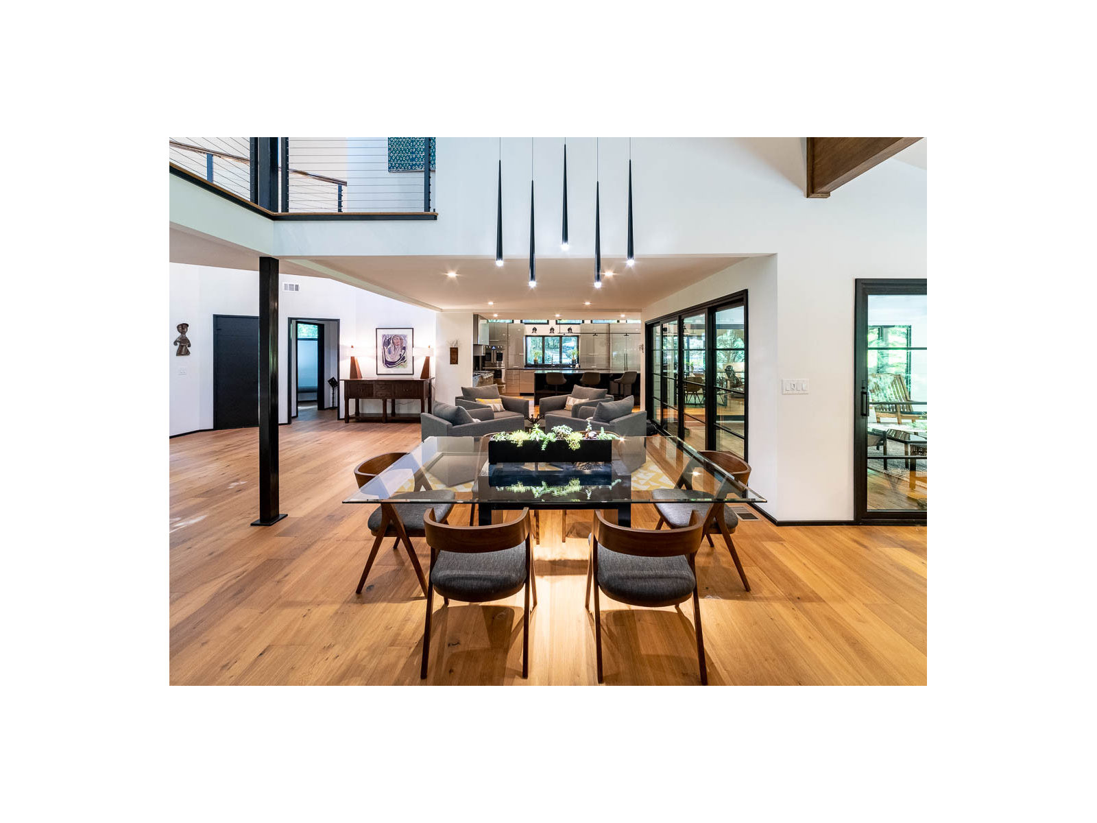 Skinner Clark whole house renovation in Alpharetta, GA by All-Square Contracting — open plan dining area with black steel windows and pendant lighting