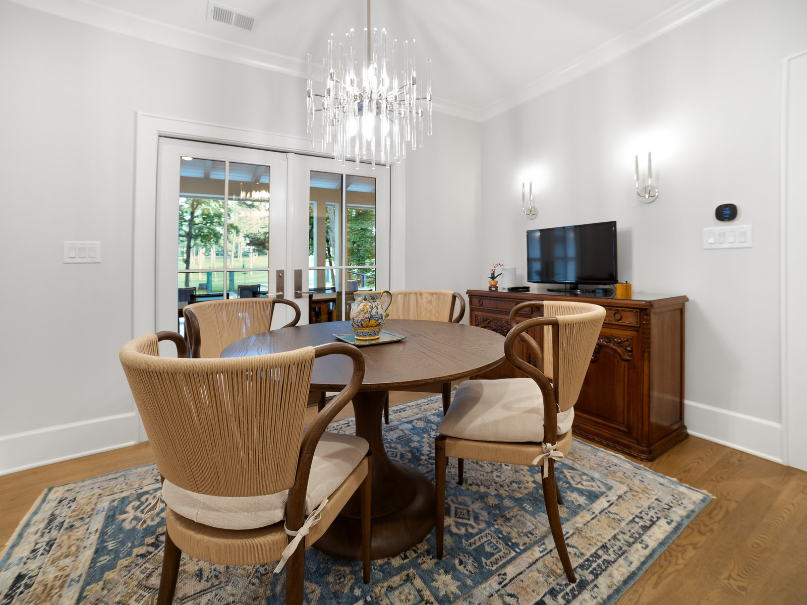 Renovated dining room with wainscot panelling, arched cased opening and hardwood floors